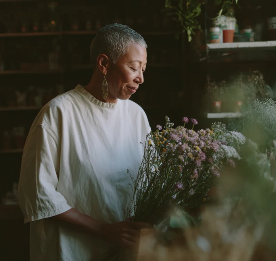 Florist arranging flowers in her shop