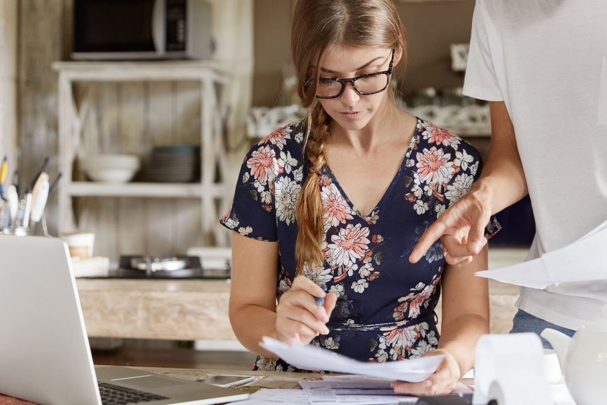 Couple managing budget together in kitchen