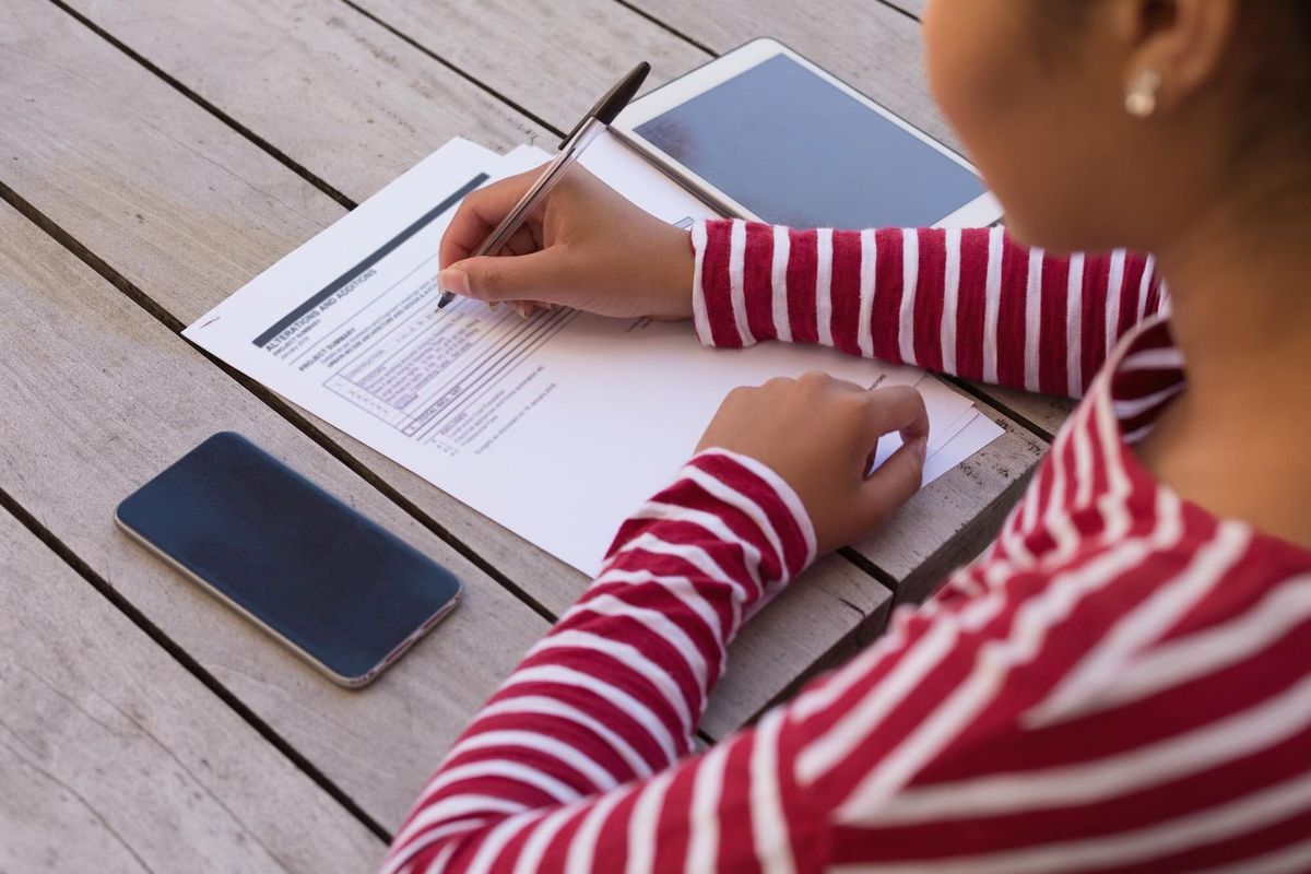 Woman filling a form at home