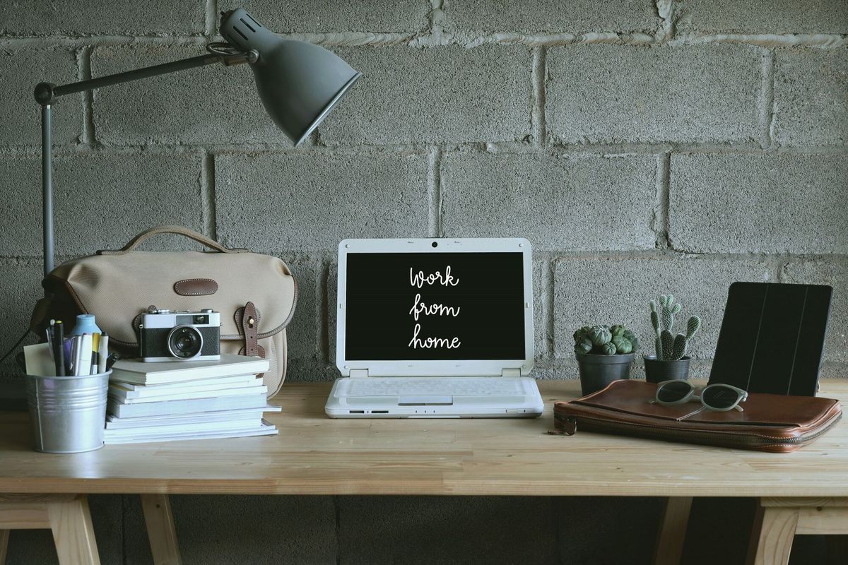 Work from home hand lettering on computer screen and accessories